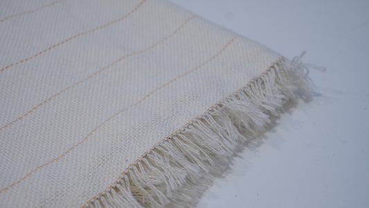 Close-up of primary tufting backing cloth weave and yellow guide lines