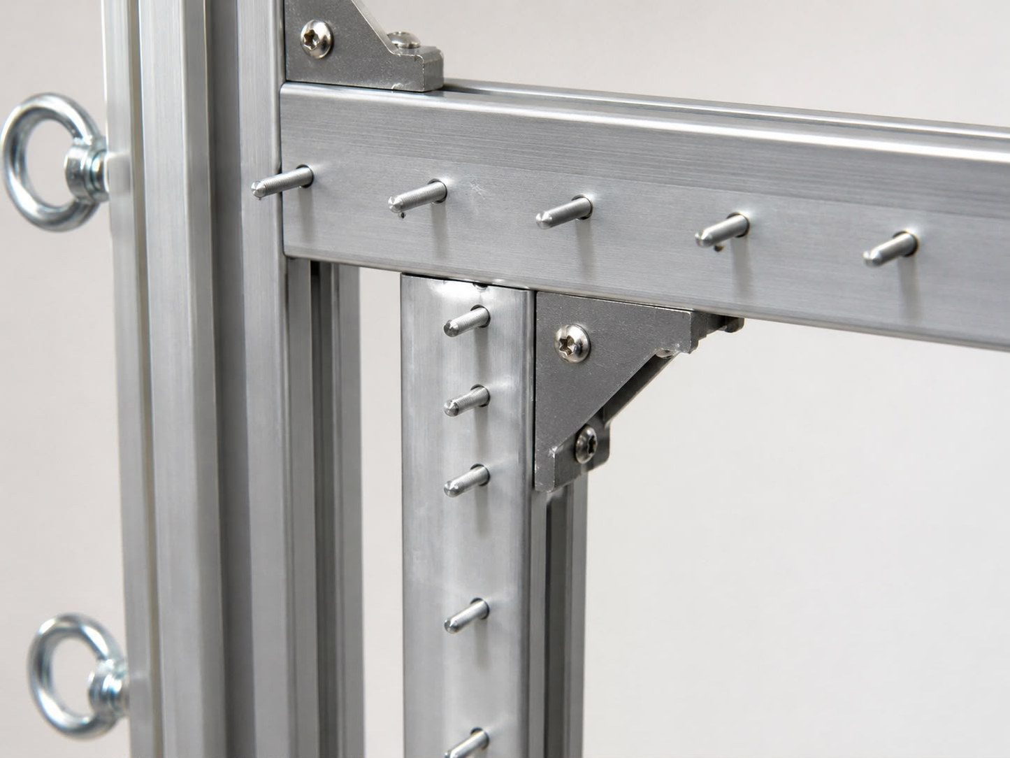 Close-up of aluminium tufting frame gripper pins and reinforced corner bracket