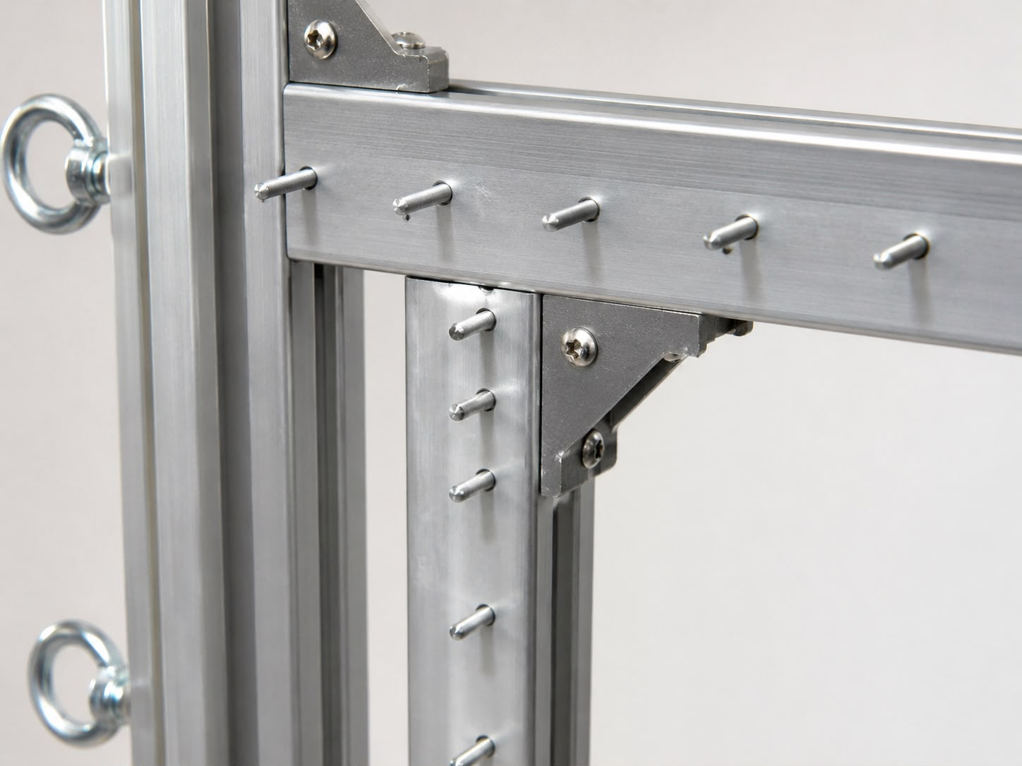 Close-up of aluminium tufting frame gripper pins and reinforced corner bracket