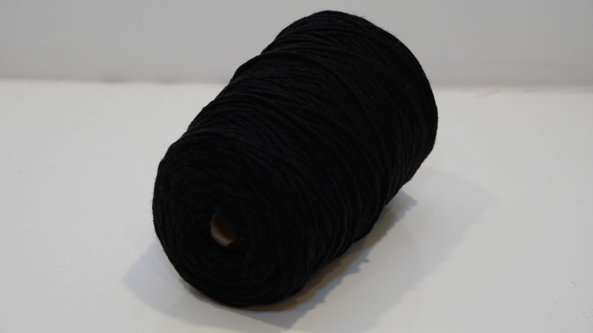 Black tufting yarn single skein angled view