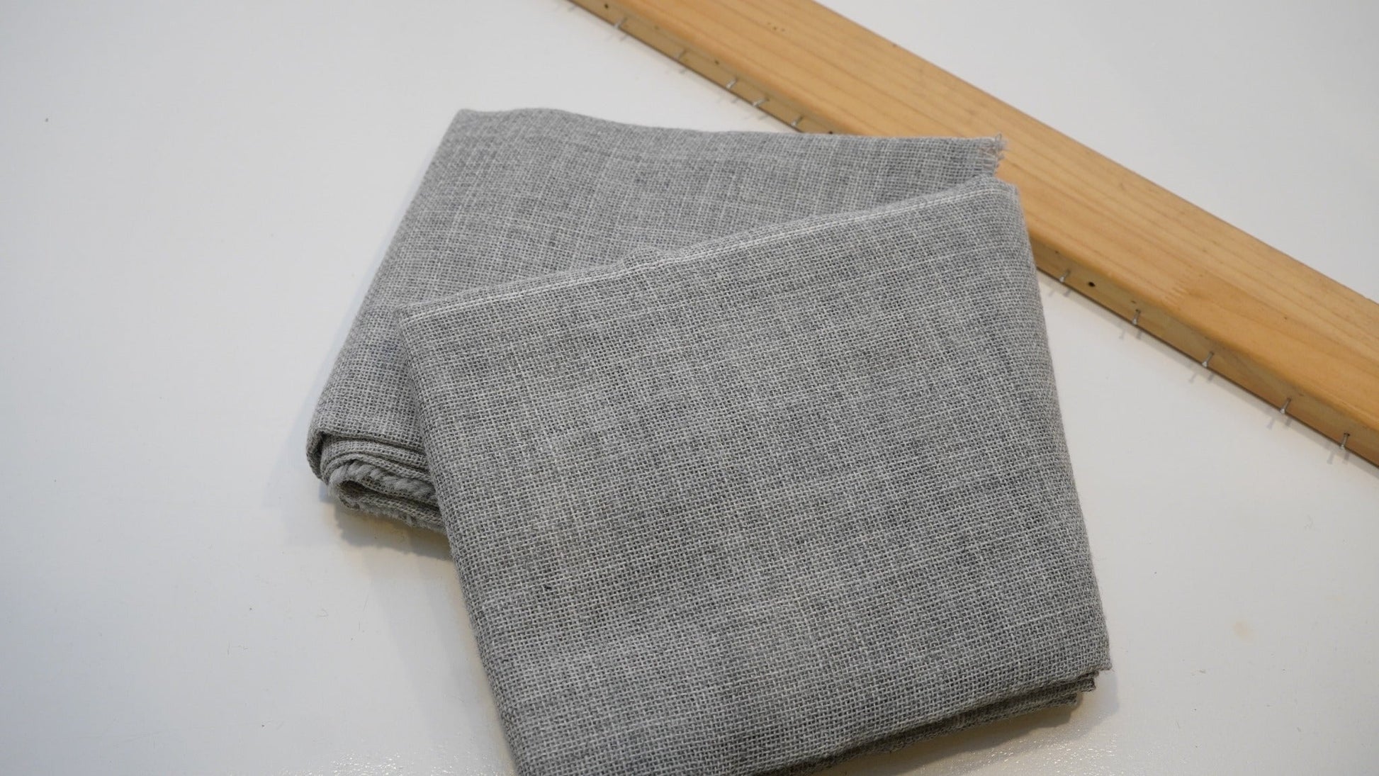 Grey premium backing cloth folded on a studio table