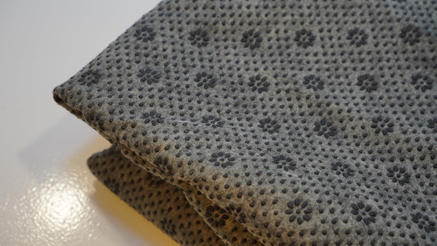 Grey non-slip rug backing fabric edge detail