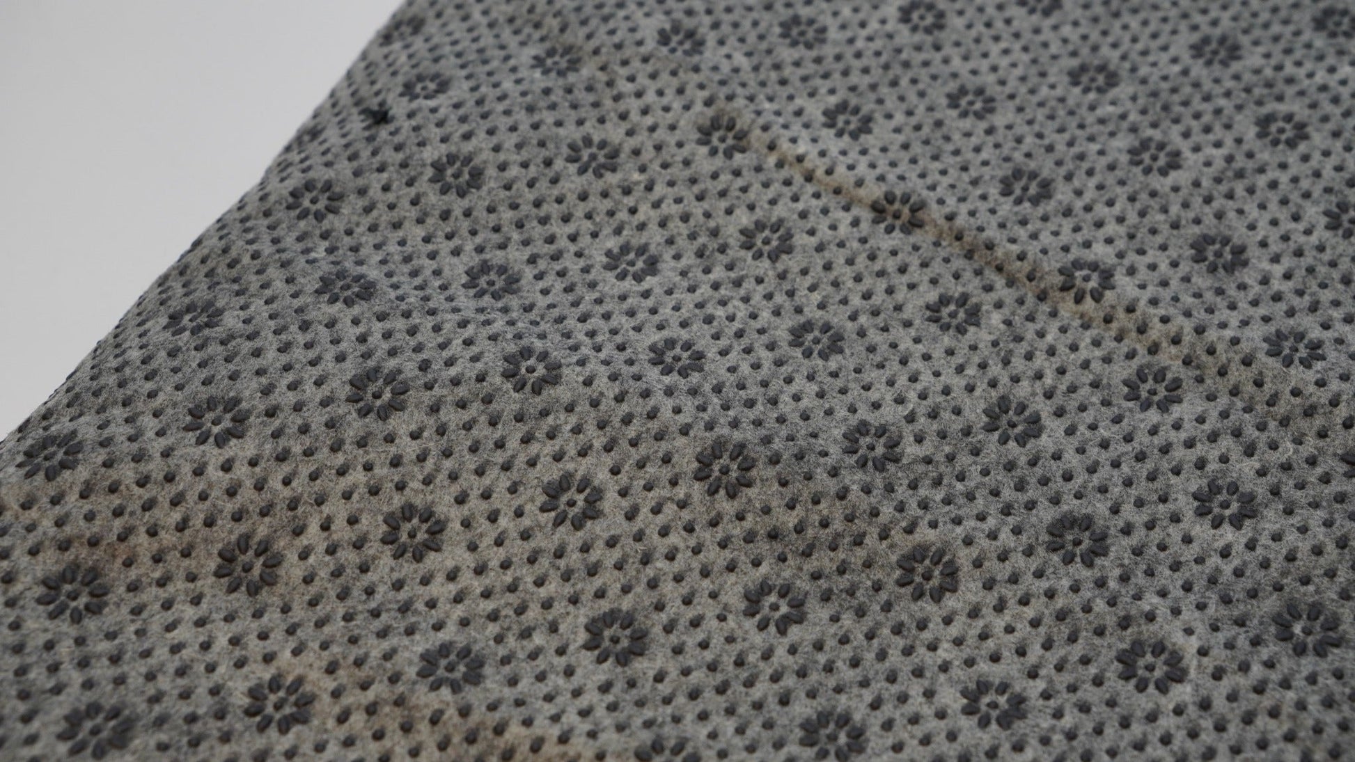 Grey rug backing cloth with anti-slip grip pattern