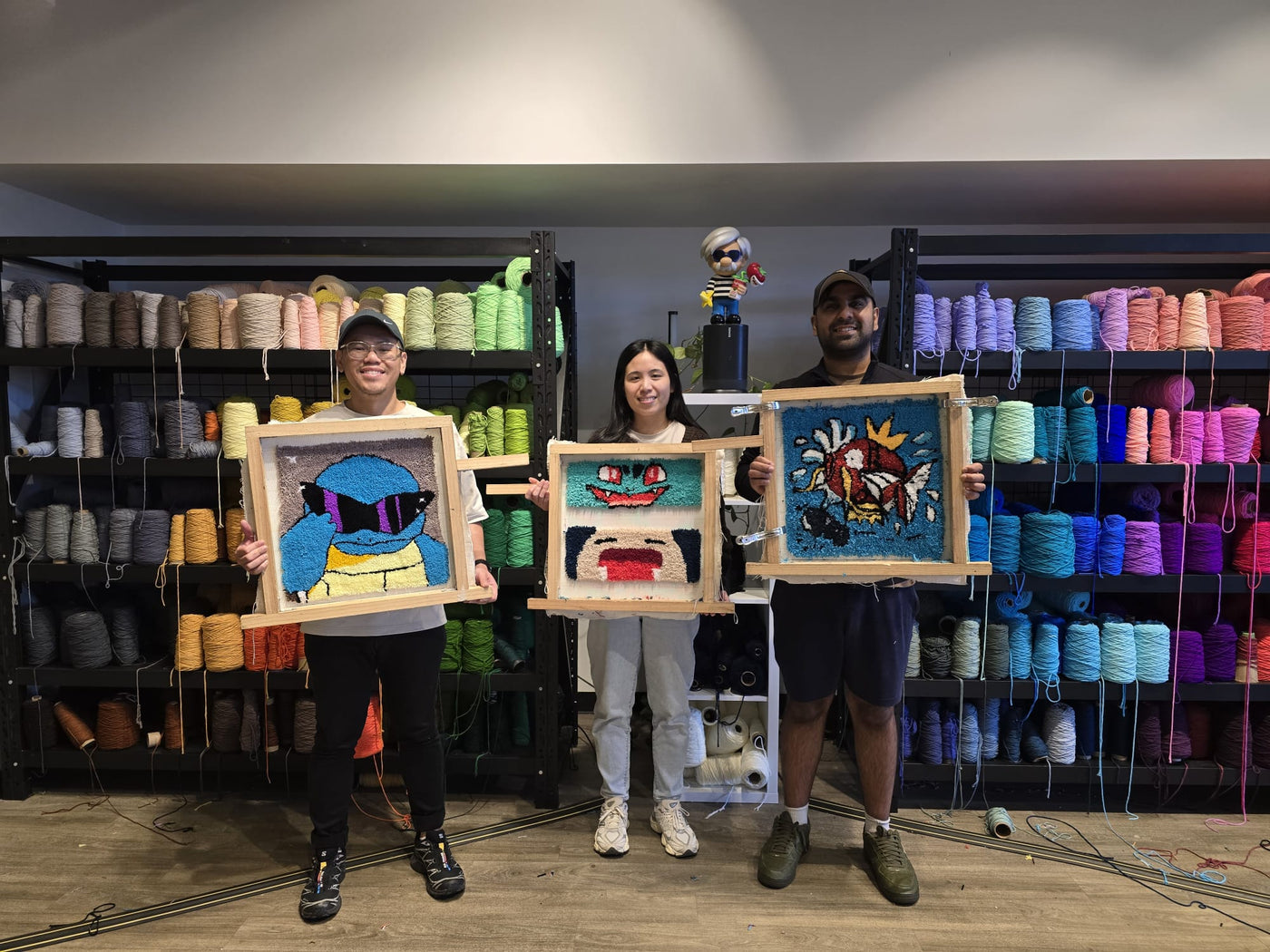 Customers holding finished 50 x 50 cm rugs at Tuft and Craft Sydney
